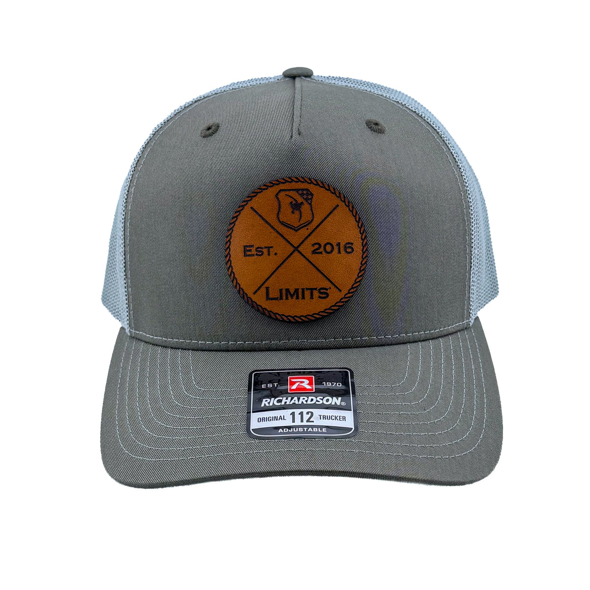 A Richardson 112fp trucker hat with a Beetle colored front and a Quarry colored mesh back, featuring a circular brown leather patch on the front with 'EST. 2016 LIMITS' logo.