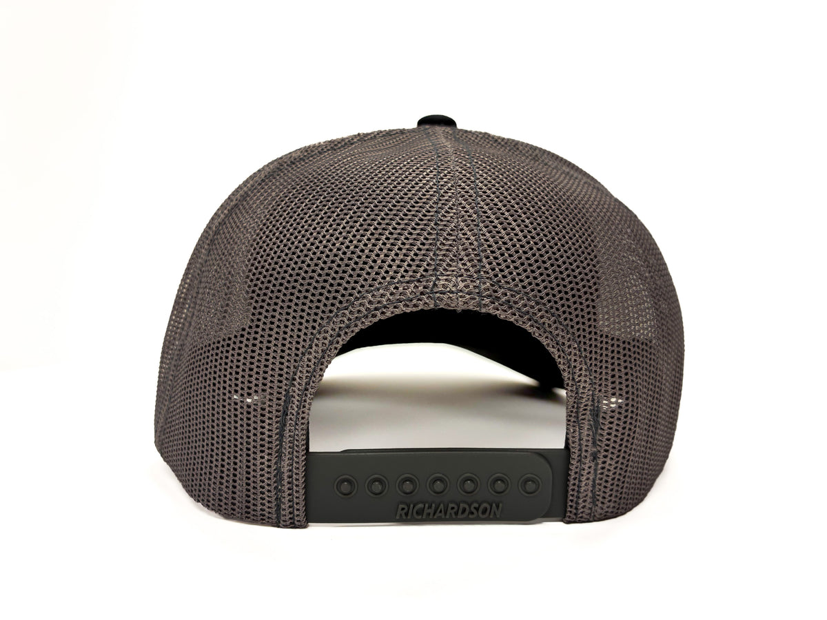 Rear view of a charcoal gray mesh trucker cap with a black adjustable snapback closure, featuring the brand name 'RICHARDSON' printed on the black strap.