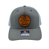 A Richardson 112fp trucker hat with a Beetle colored front and a Quarry colored mesh back, featuring a circular brown leather patch on the front with 'EST. 2016 LIMITS' logo.