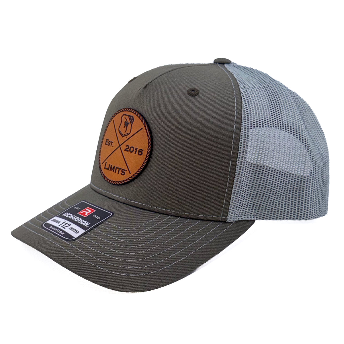 A Richardson 112fp trucker hat with a Beetle colored front and a Quarry colored mesh back, featuring a circular brown leather patch on the front with 'EST. 2016 LIMITS' logo.