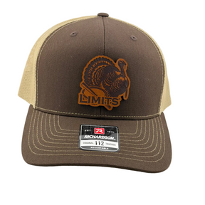 A Richardson 112 trucker hat in brown and dark khaki mesh, featuring a brown leather patch with a turkey design and the text 'LIMITS' on the front. The Richardson brand sticker is visible on the brim.